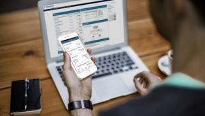 onlinebanking-man-using-mobile-app-and-laptop